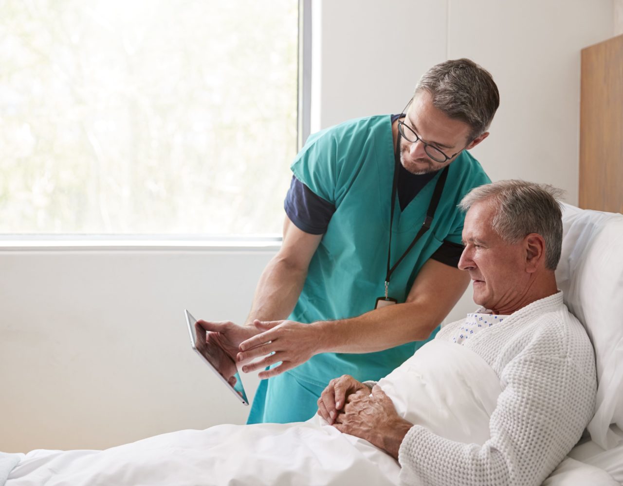 A doctor showing digital reports to his patient