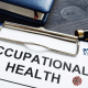 Occupational health report, pen and notepad.